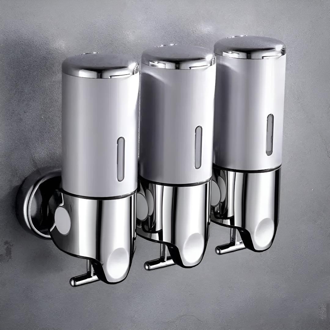 Triple wall mounted soap dispenser with pump levers for shampoo, conditioner, body wash.